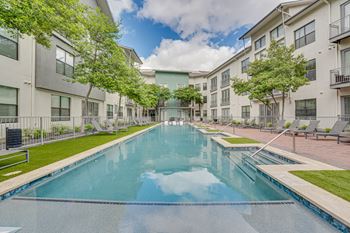 Swimming pool surrounded by modern apartment buildings